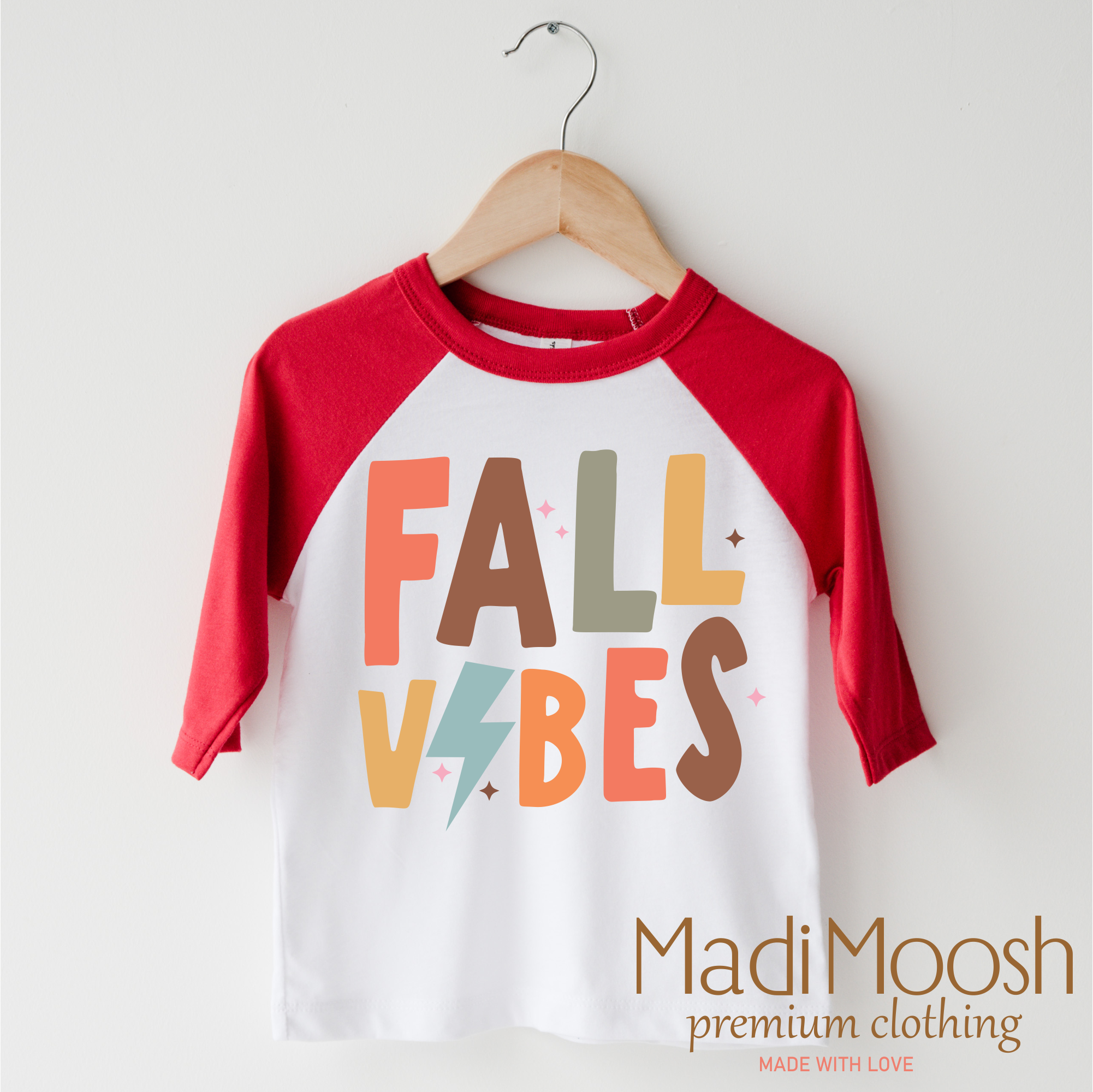 Children's 3/4 sleeve shirt with 'Fall Vibes' text on a hanger, branded as Madi Moosh.