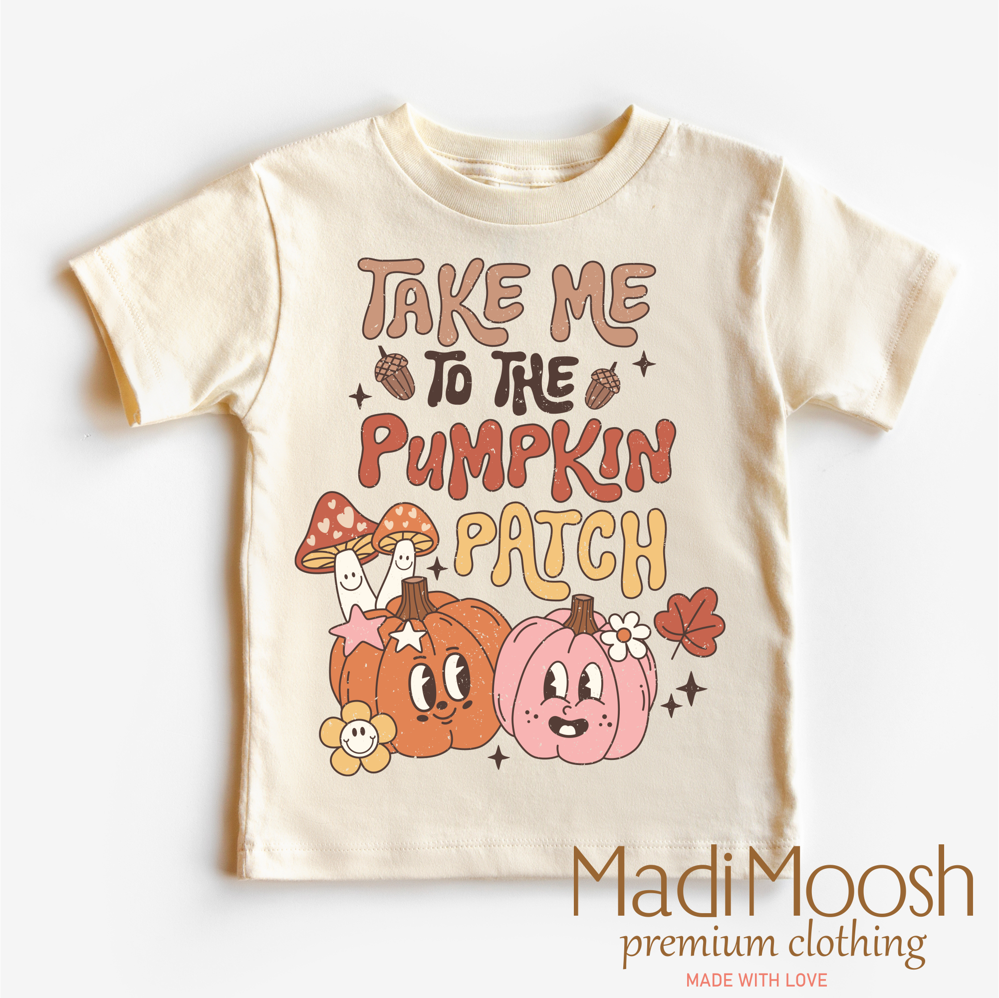 Children's t-shirt with 'Take Me to the Pumpkin Patch' text and cartoon pumpkins on a white background.
