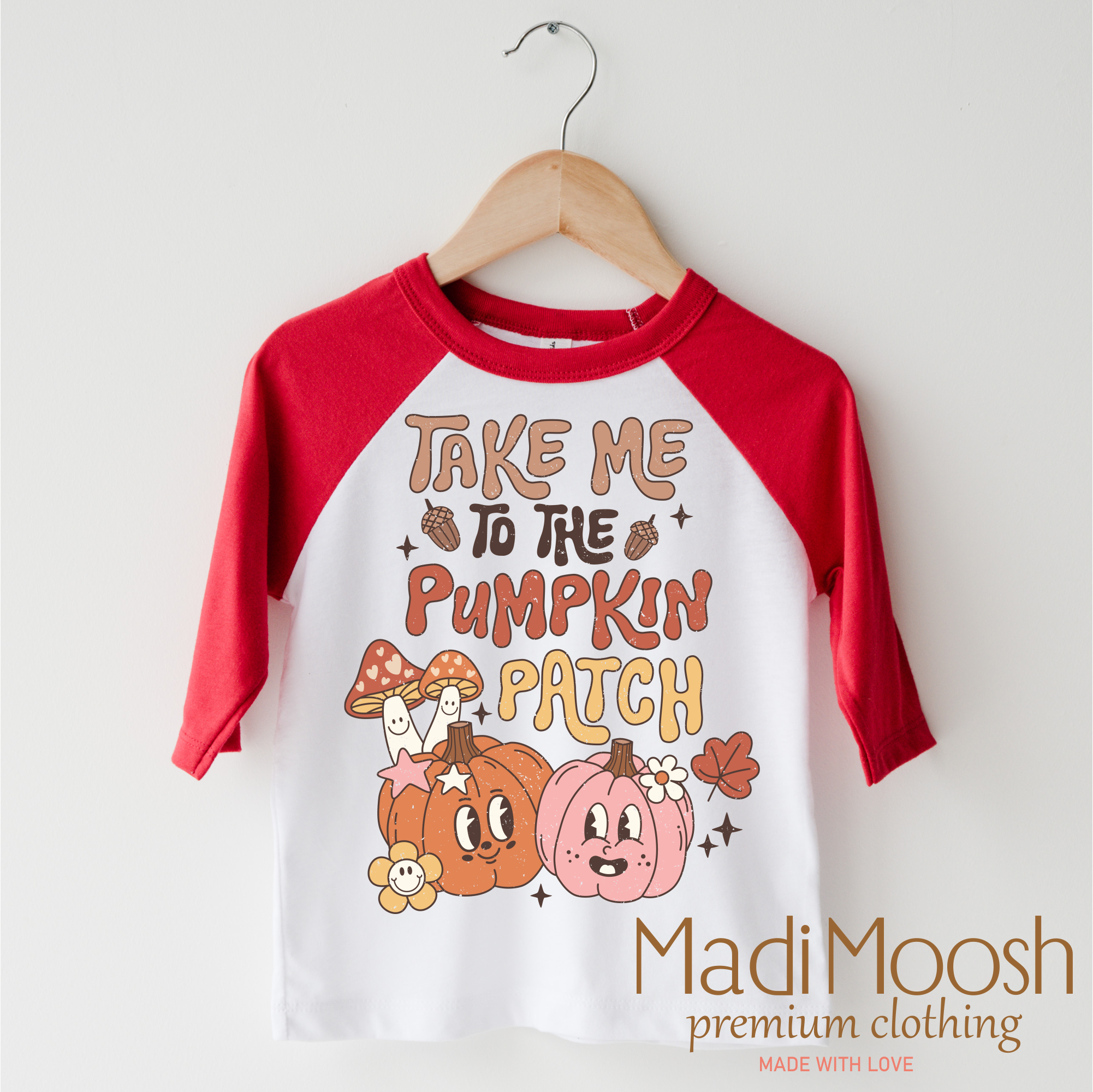 Children's 3/4 sleeve shirt with 'Take Me to the Pumpkin Patch' design on a hanger, featuring the brand 'Madi Moosh'.