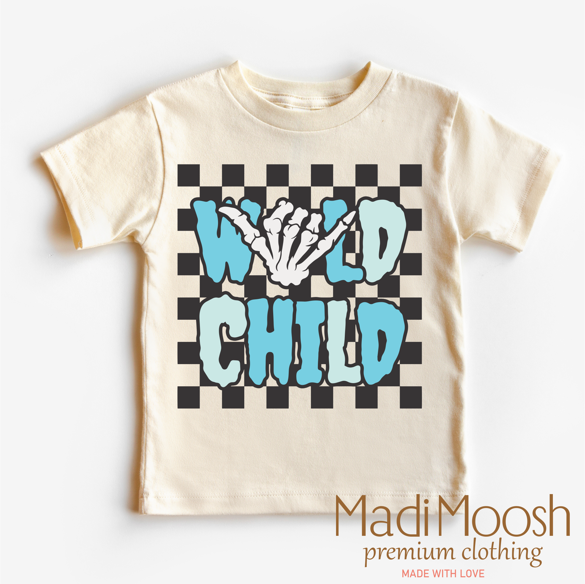 Beige t-shirt with 'Wild Child' graphic design on a checkered background, brand 'Madi Moosh' visible.