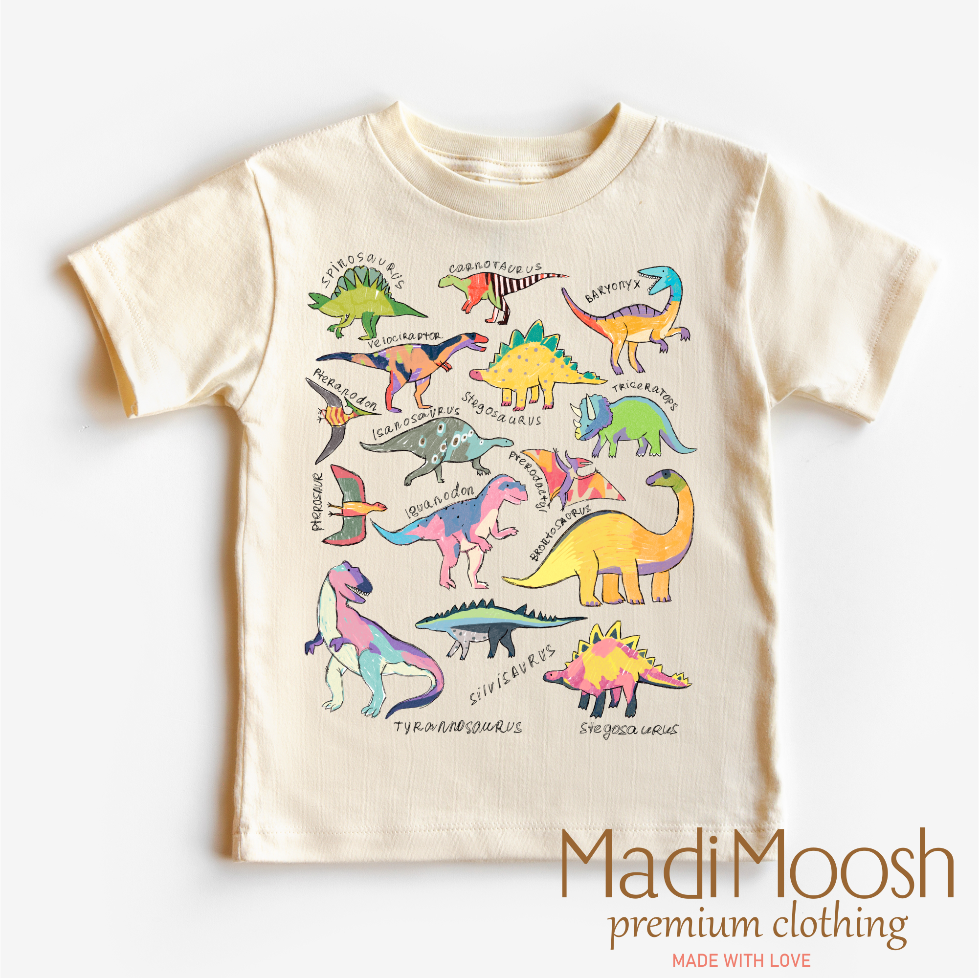 Children's t-shirt with colorful dinosaur illustrations on a white background, featuring the brand 'Madi Moosh'.