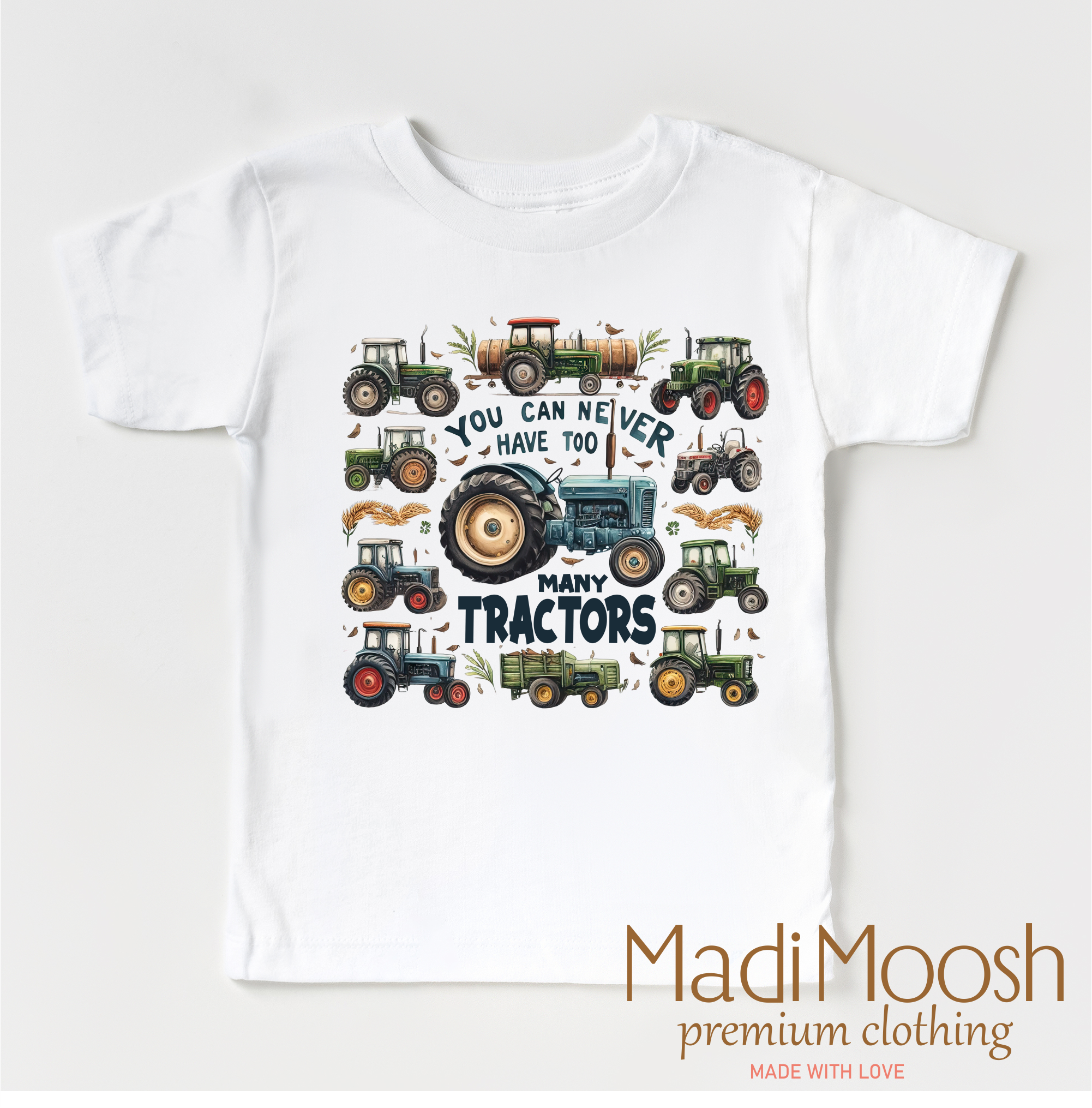 White t-shirt with tractor design and text 'You can never have too many tractors' by Madi Moosh on a white background.