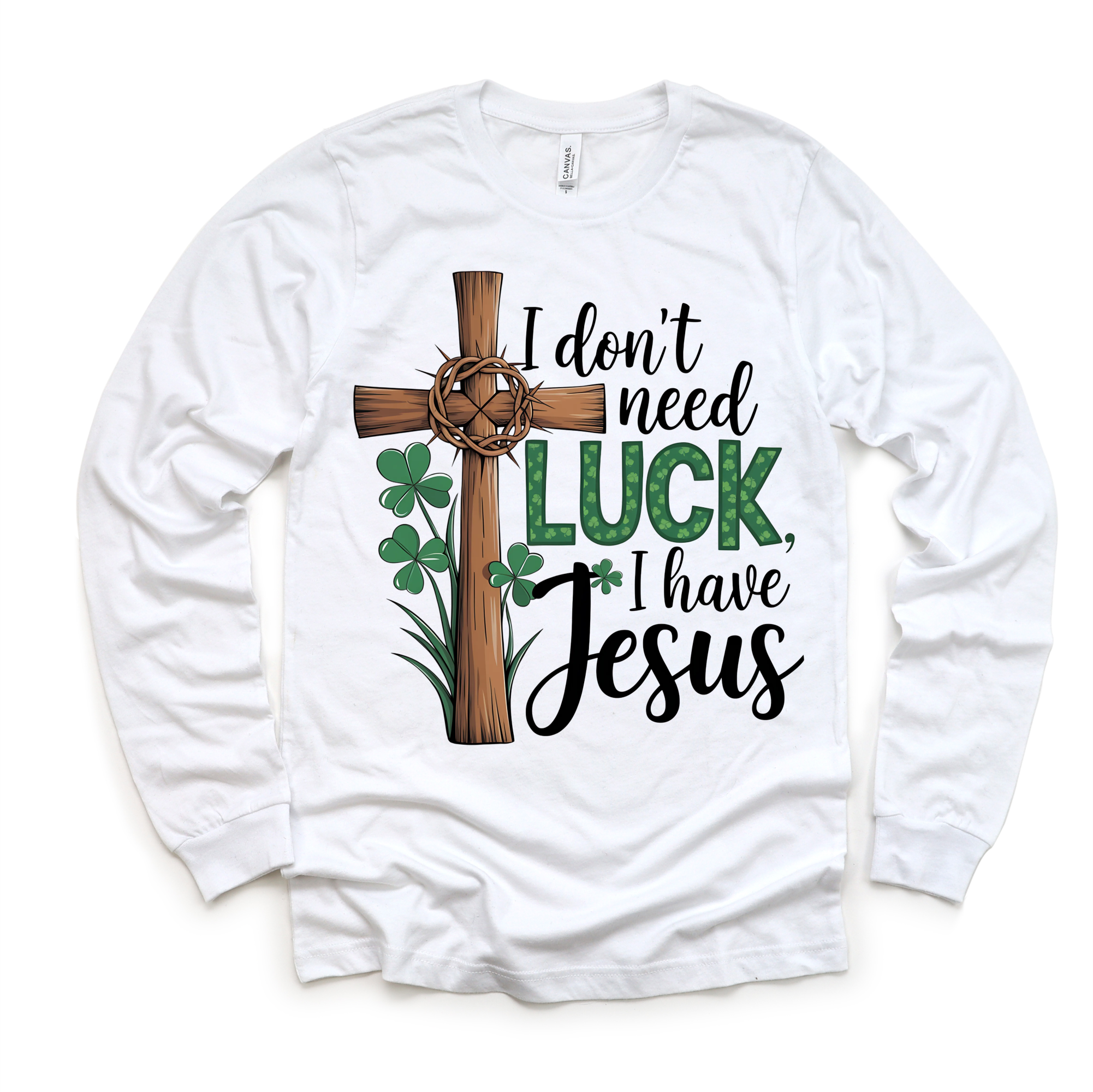 White long-sleeve shirt with a cross, shamrocks, and text 'I don't need luck, I have Jesus' on a white background.
