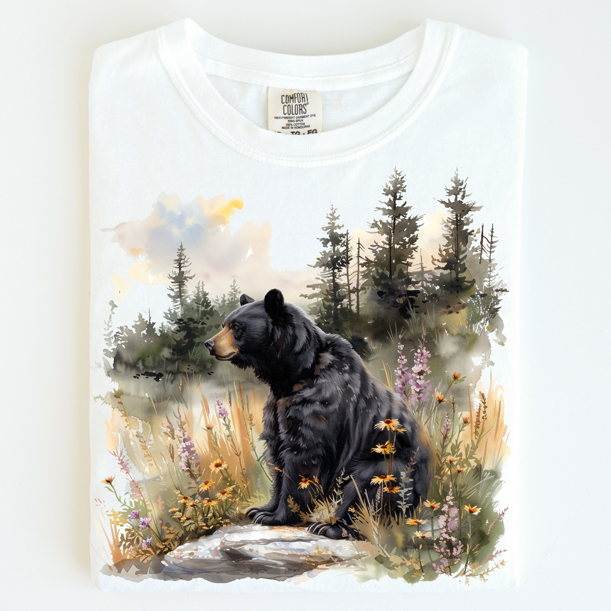 White t-shirt with a bear and nature design on a white background