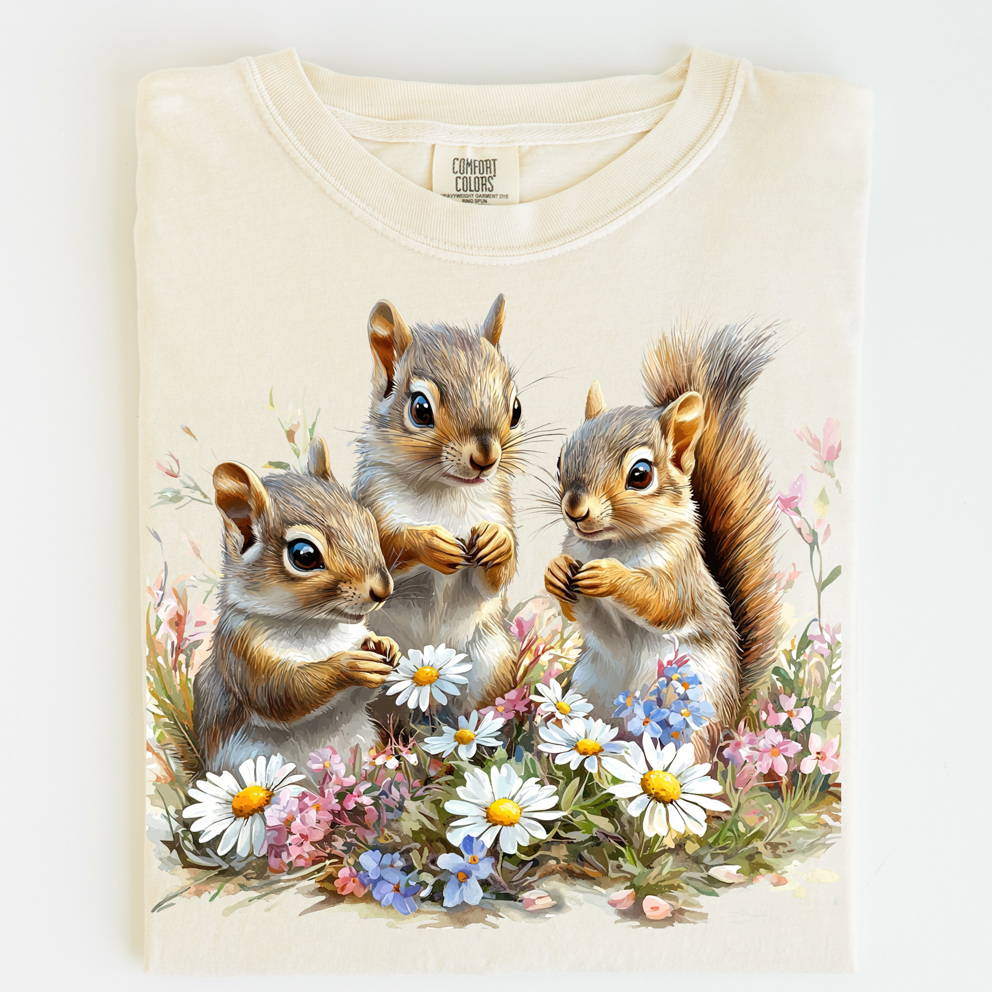 T-shirt with a design of three squirrels and flowers on a white background