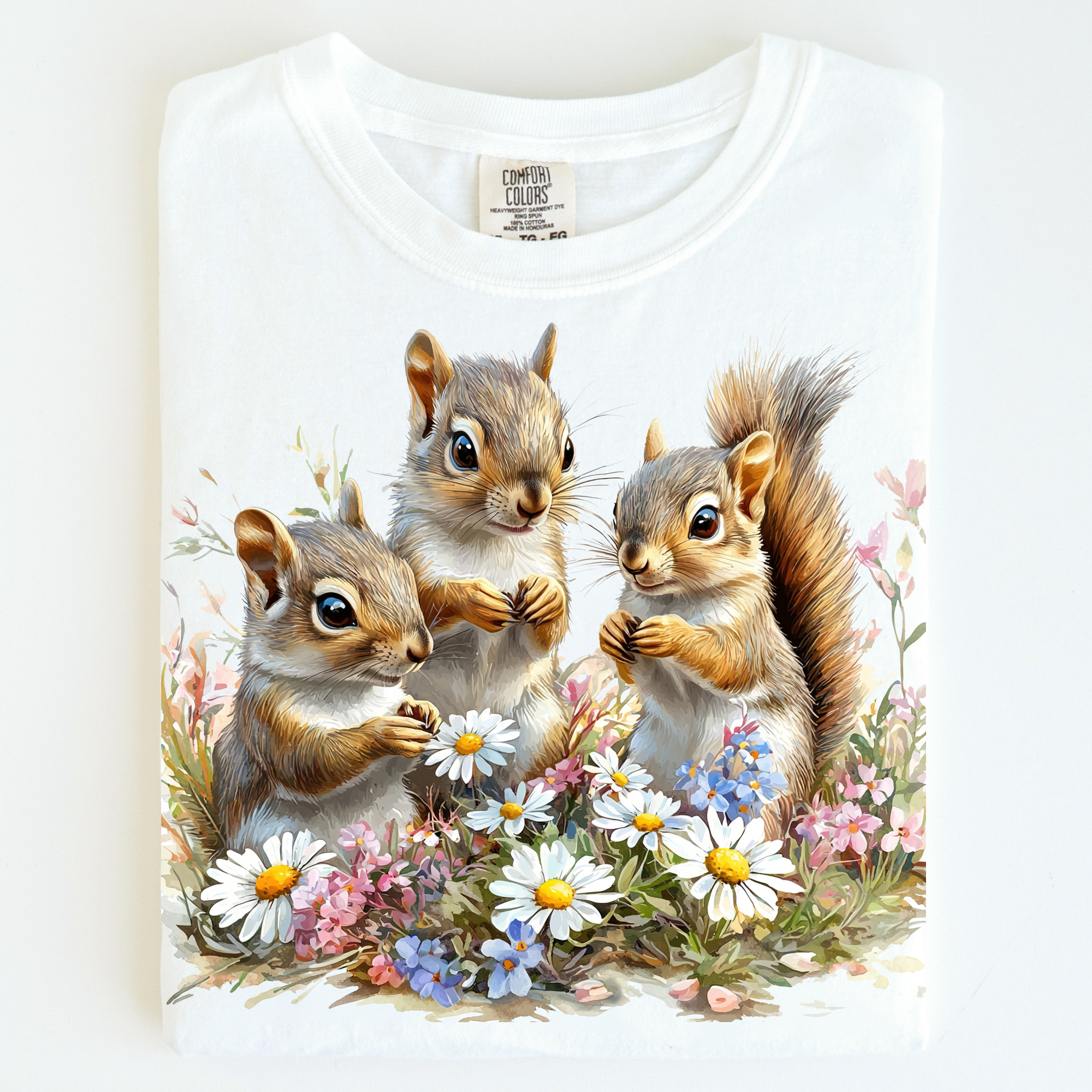 T-shirt with a design of three squirrels and flowers on a white background