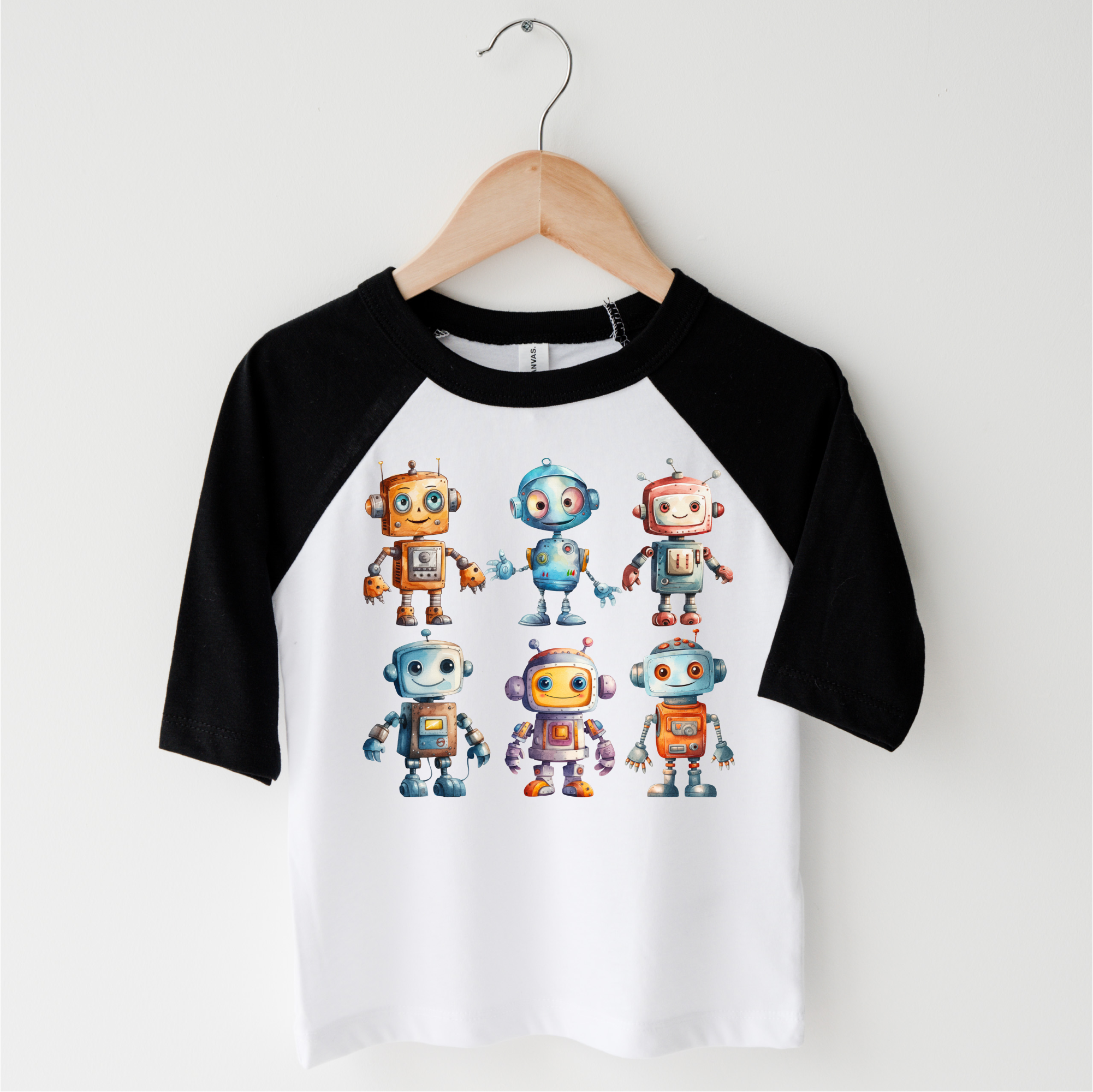 Children's 3/4 length sleeve shirt with robot graphics on a hanger against a white background