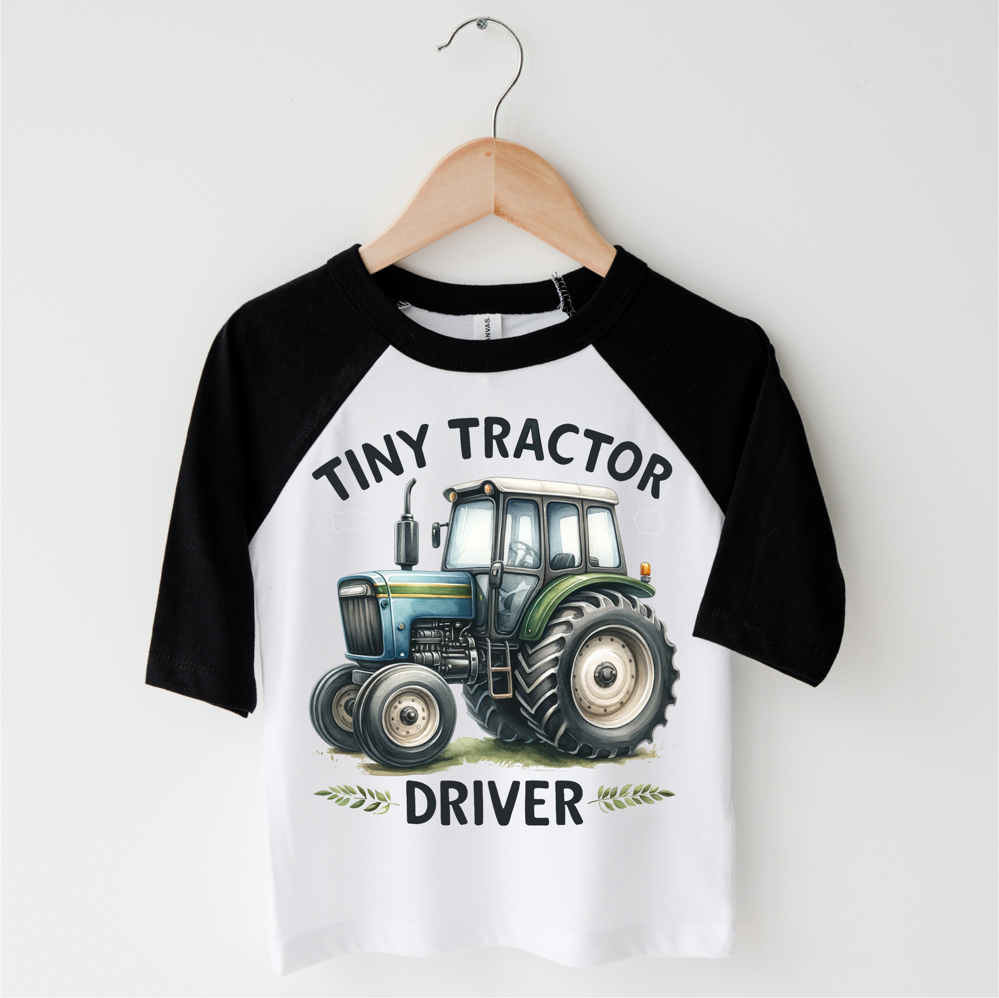 Children's 3/4 sleeve shirt with a tractor graphic and text on a white background