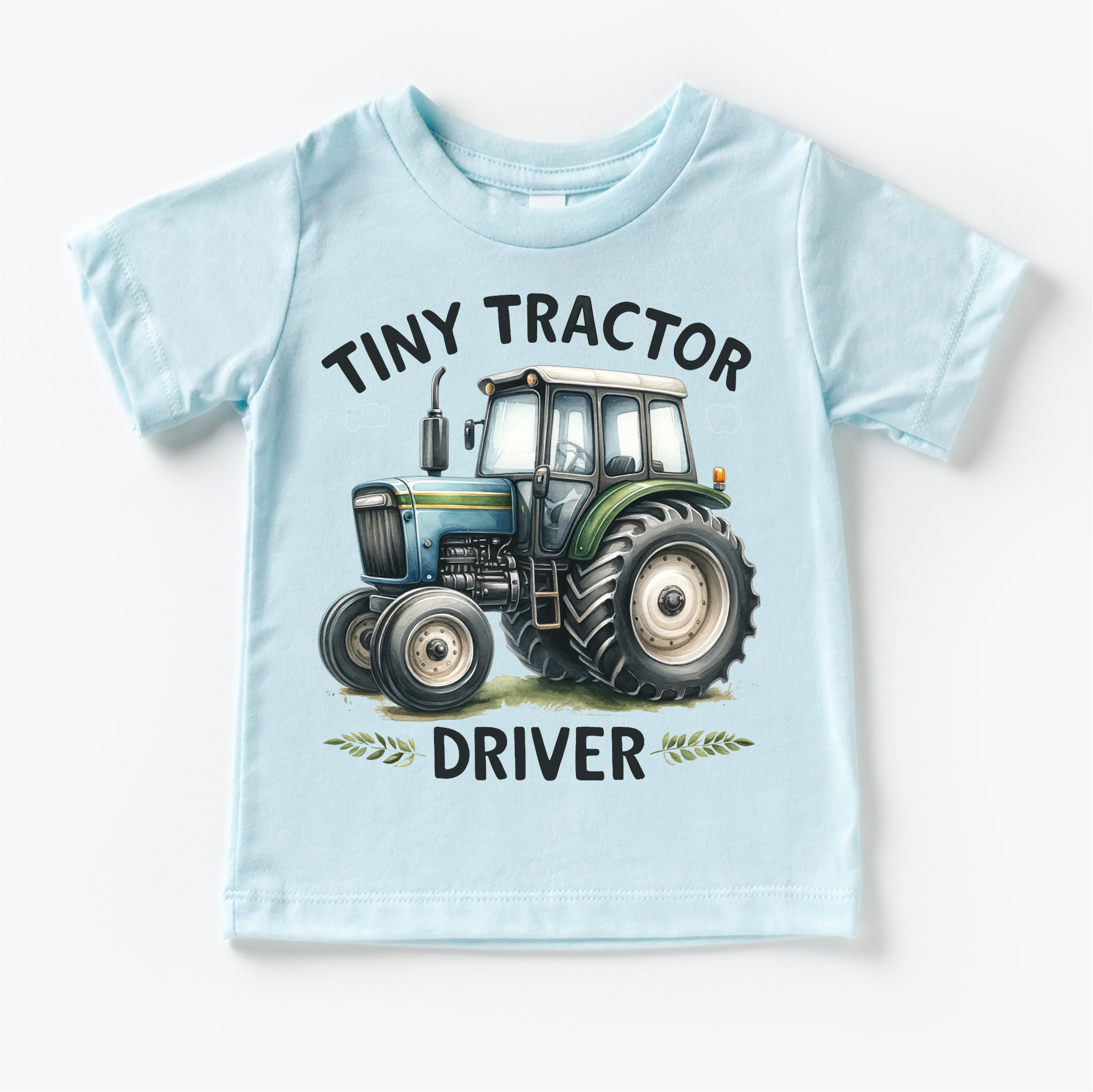 Light blue t-shirt with a tractor graphic and text on a white background