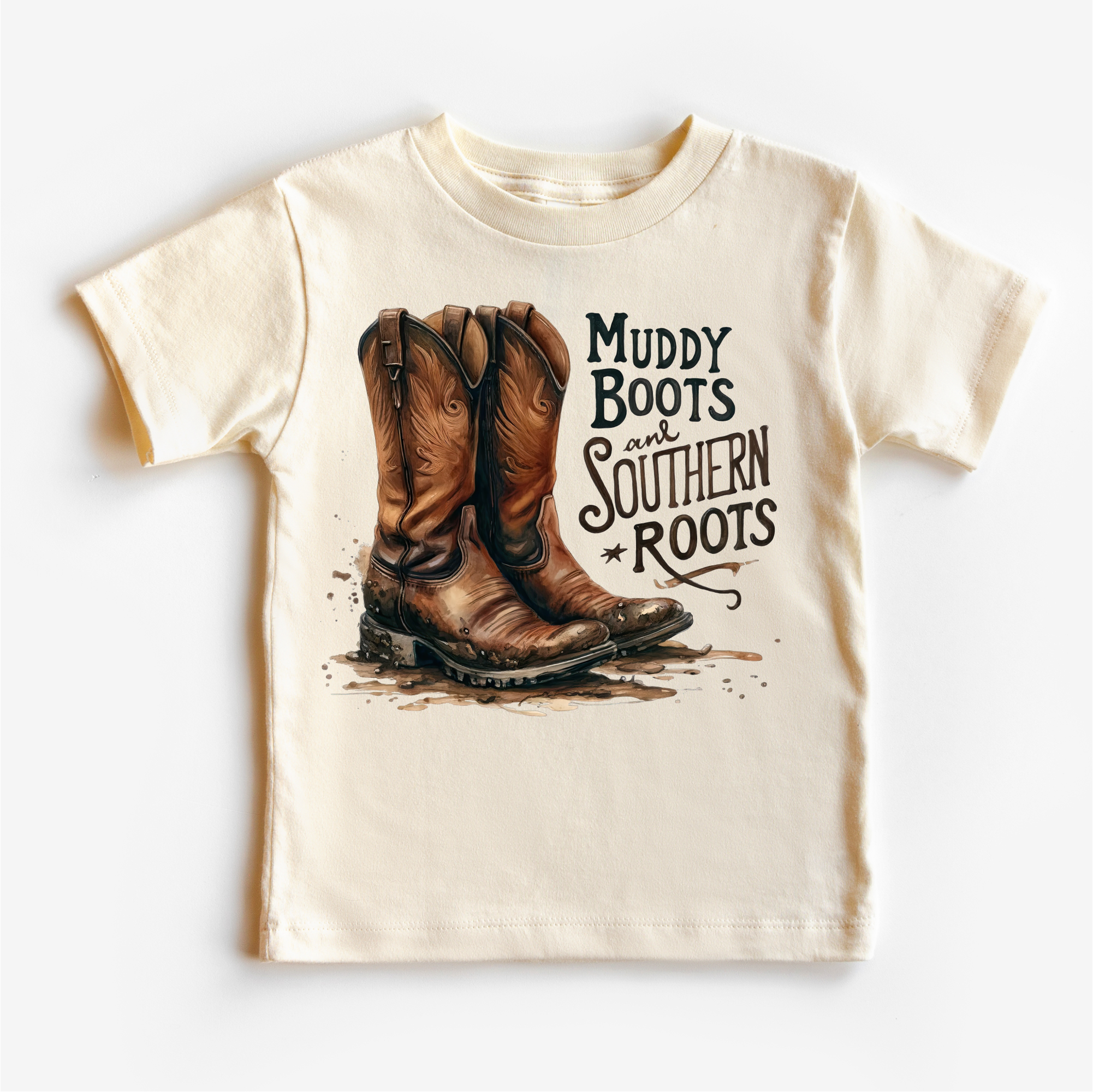 Beige t-shirt with cowboy boots and 'Muddy Boots and Southern Roots' text on a white background