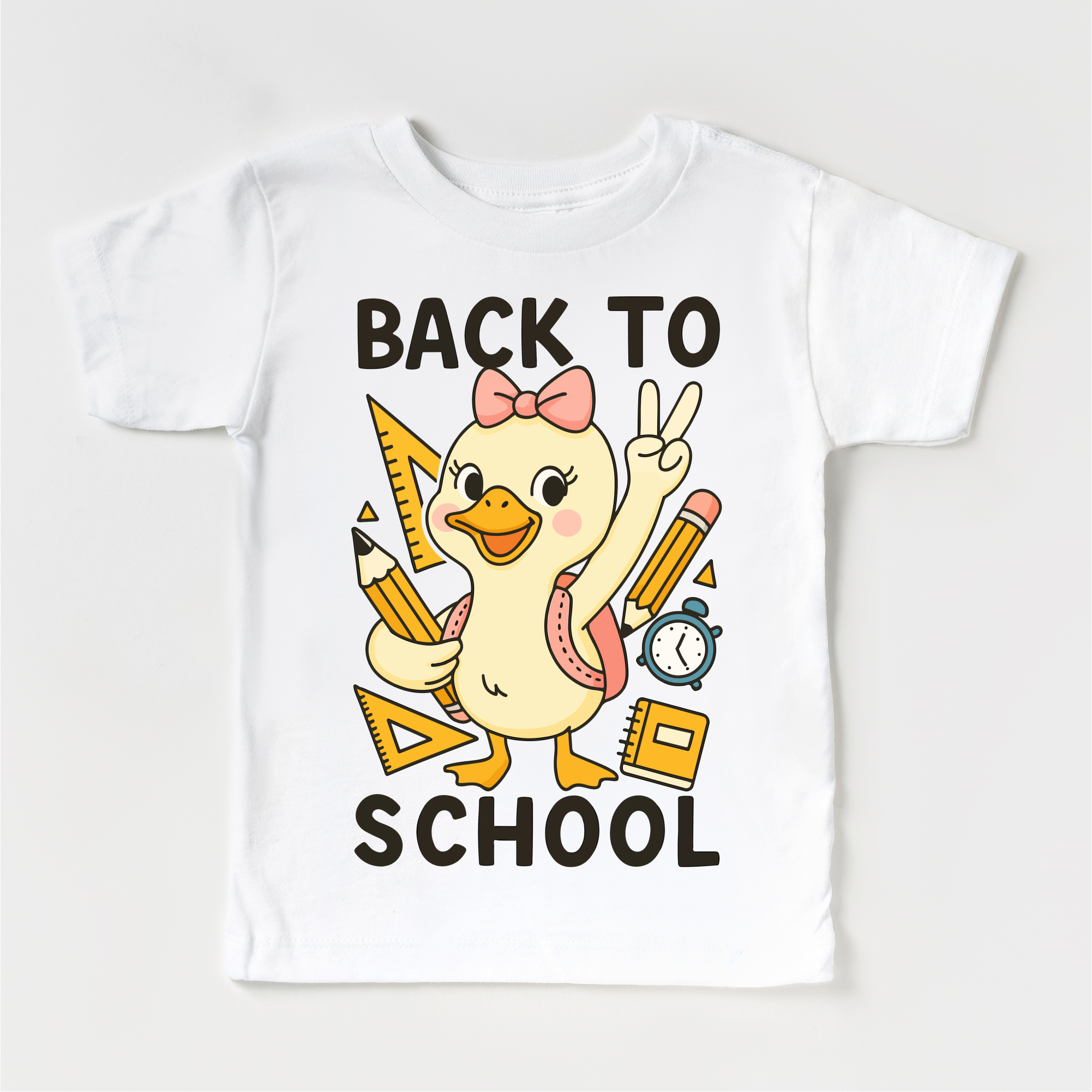 White t-shirt with a cartoon duck holding school supplies and 'Back to School' text on a white background