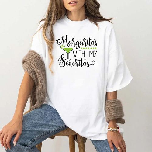 Person wearing a white t-shirt with 'Margaritas with my Senoritas' text and graphic.