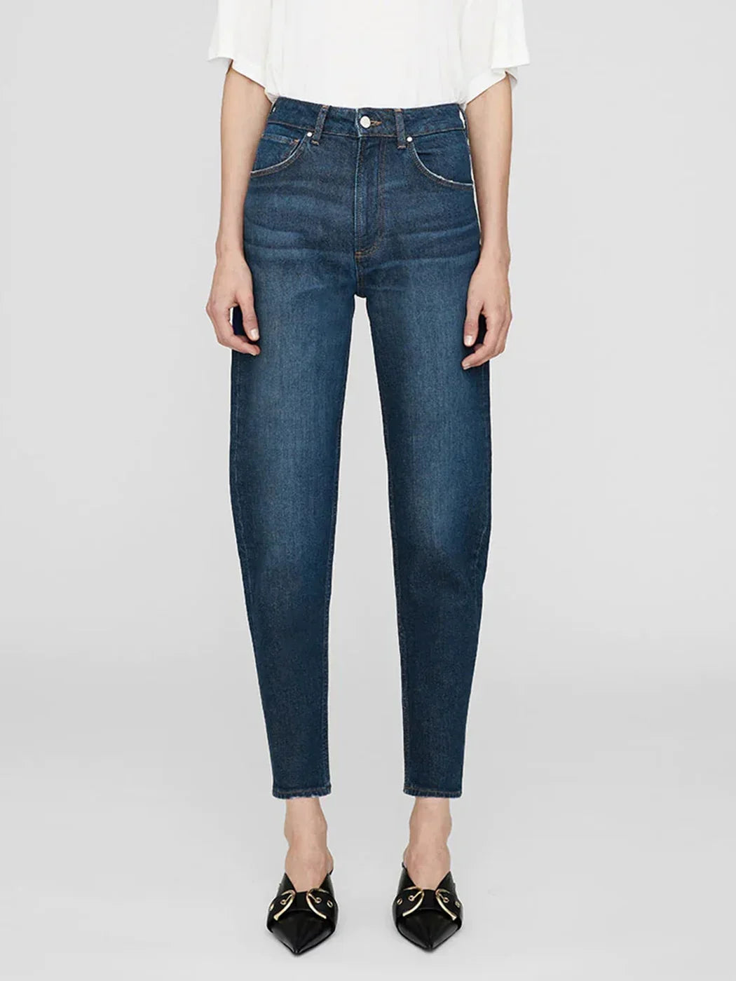 Person wearing blue jeans on a white background