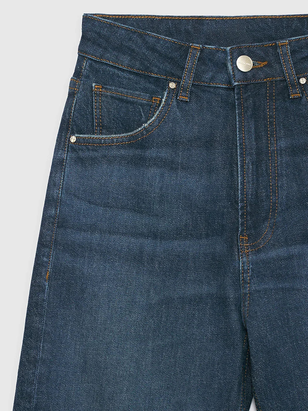 Close-up of blue jeans on a light gray background