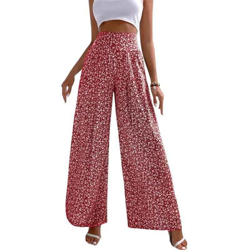 Red floral wide-leg pants worn by a person on a white background