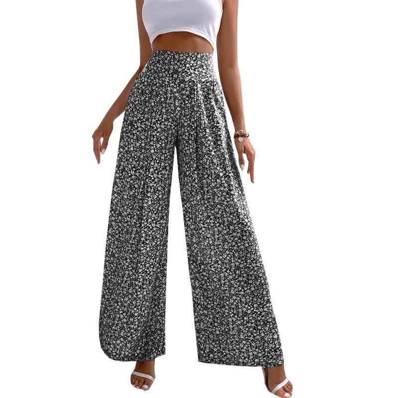 Woman wearing black floral wide-leg pants on a white background