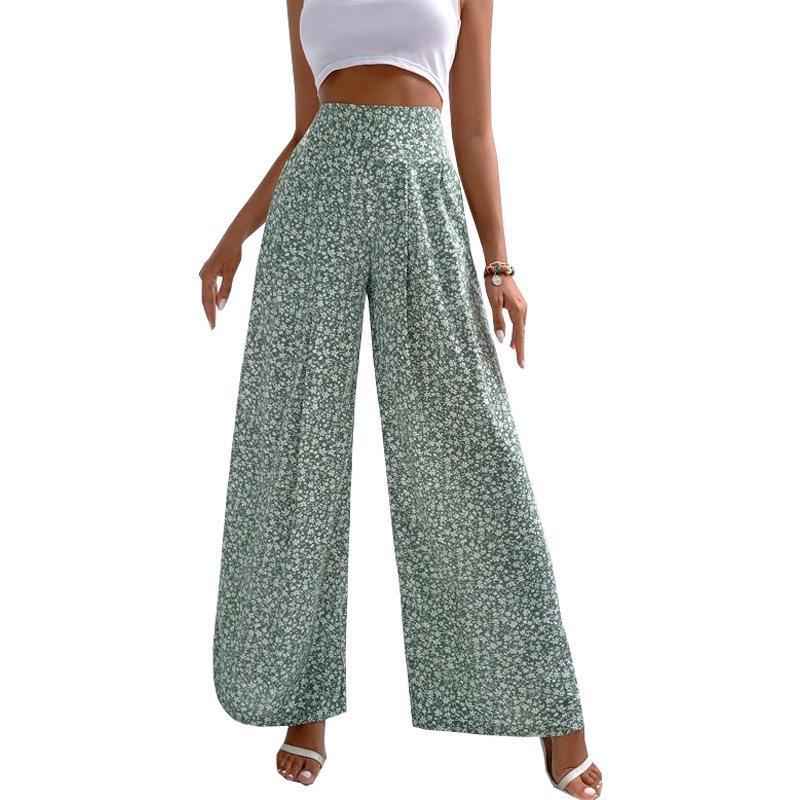 Green floral wide-leg pants worn by a person on a white background