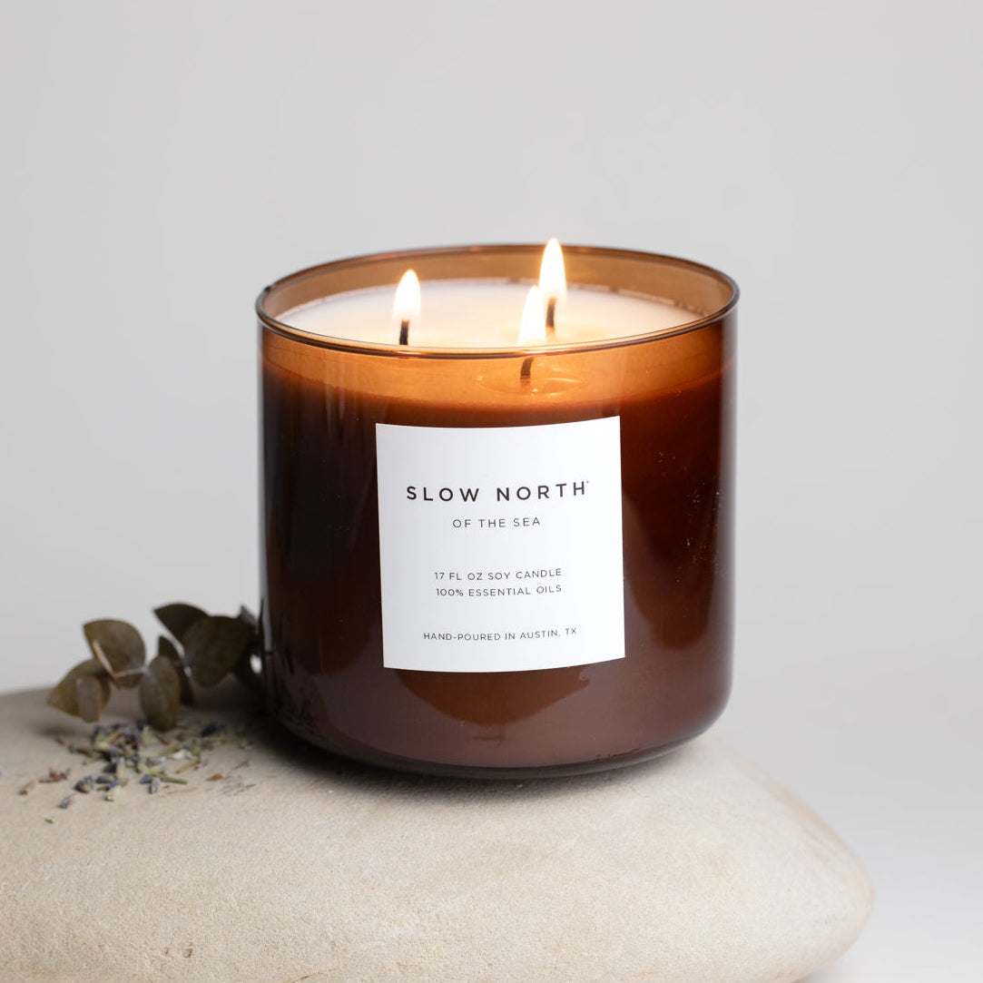 Candle with 'Slow North' label on a neutral background