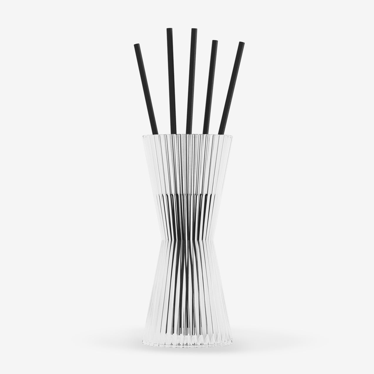 Clear vase with black rods on a white background