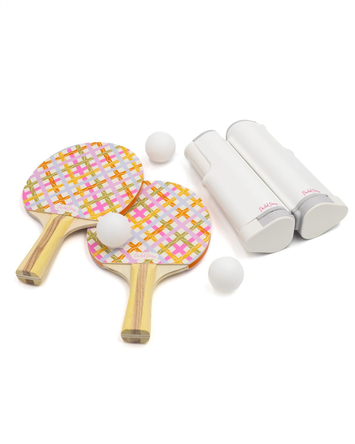 Two patterned ping pong paddles with three white balls and a white paddle holder on a white background.