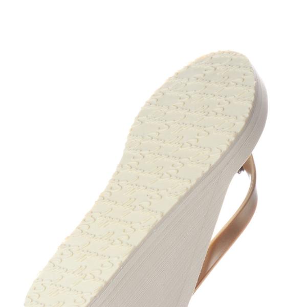 Close-up of a sandal sole with woven pattern on a white background