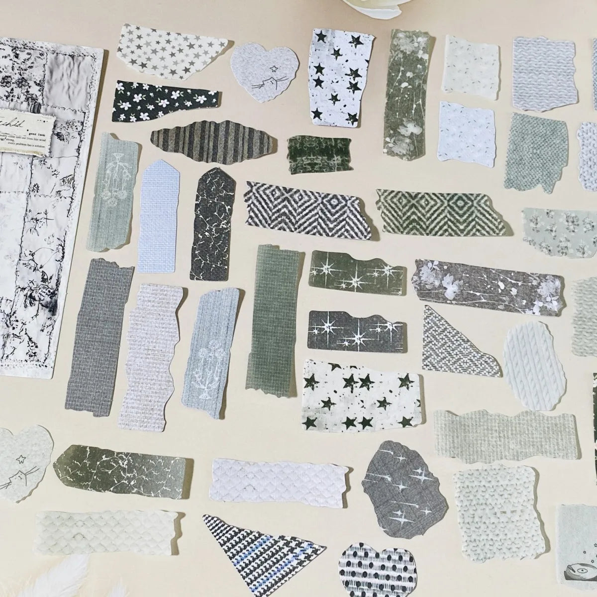 Collection of various patterned paper pieces on a beige background
