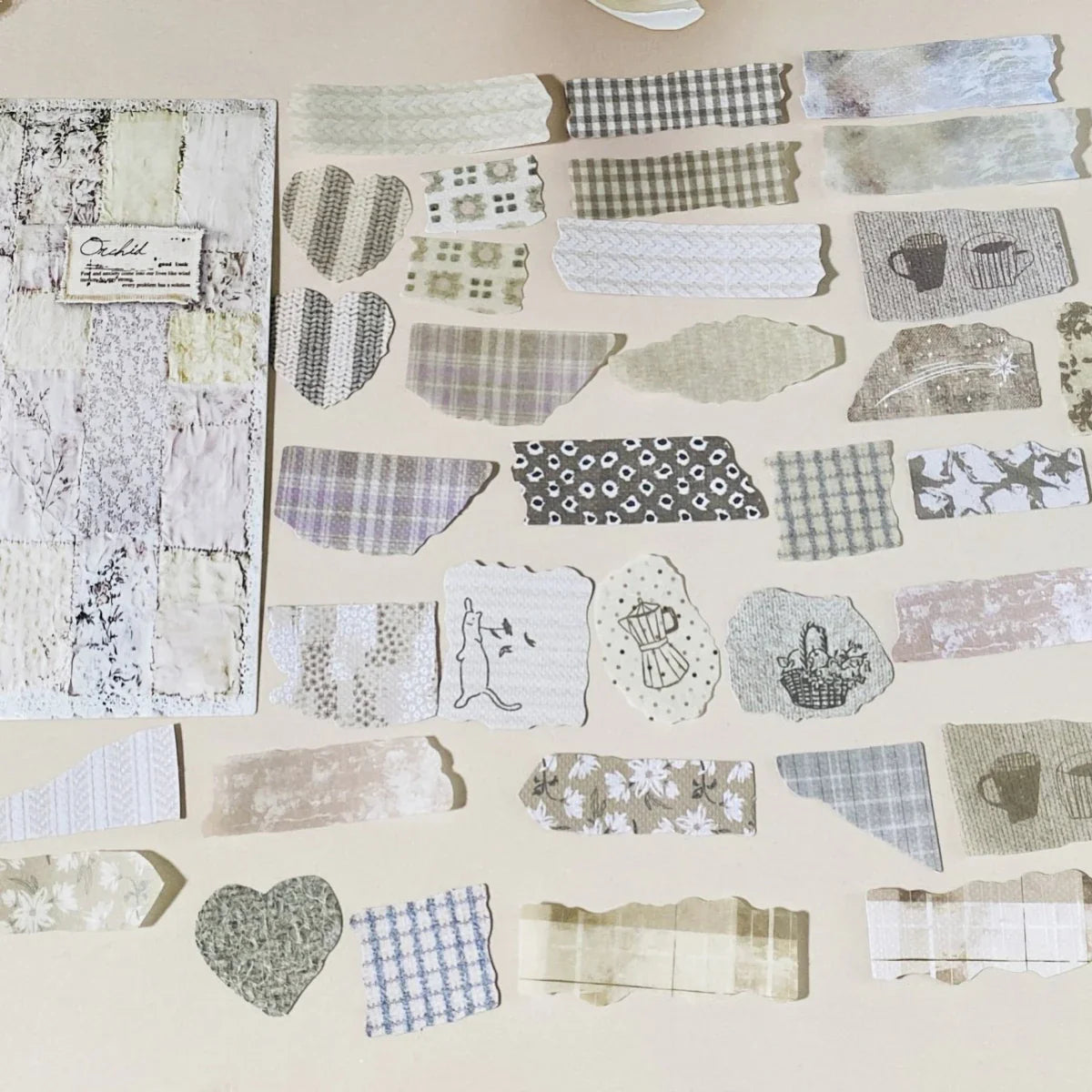 Collection of patterned paper strips on a beige background