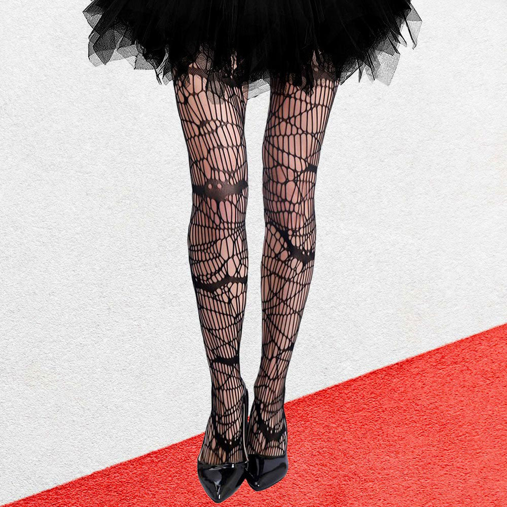 Person wearing black fishnet tights and a black tutu on a red and white striped background