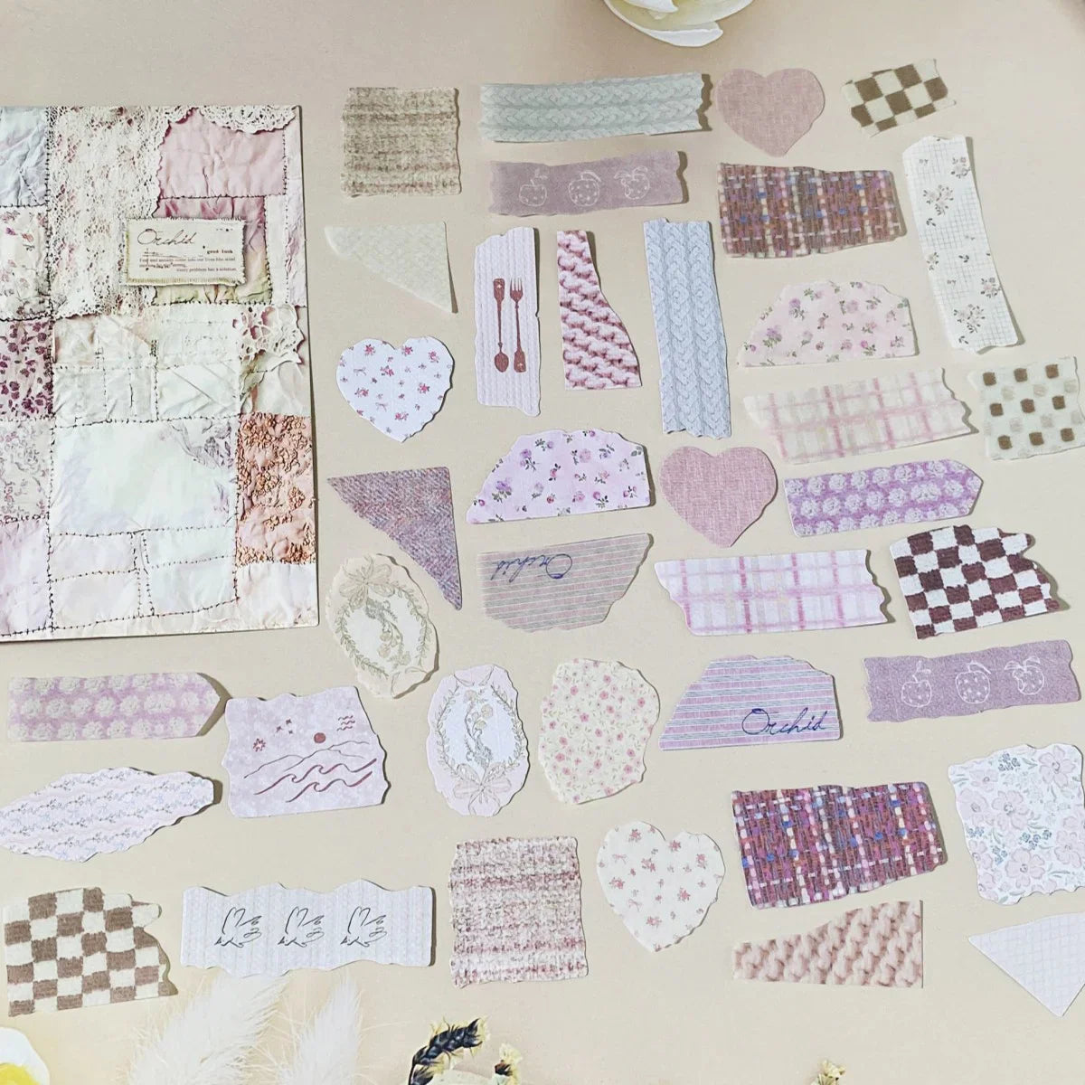 Collection of various textured paper pieces on a beige surface
