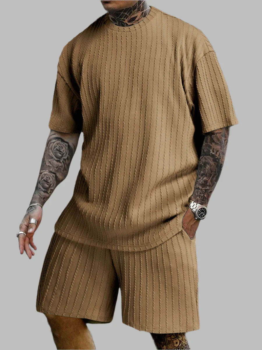 Person wearing a brown ribbed knit outfit on a gray background