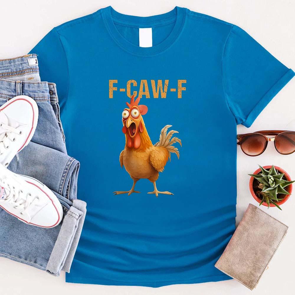 Blue t-shirt with a cartoon rooster and 'F-CAW-F' text, surrounded by jeans, sneakers, sunglasses, and a plant.