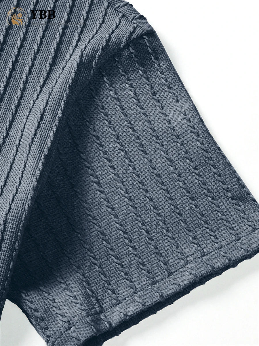 Close-up of a textured dark gray fabric with a brand logo in the corner.