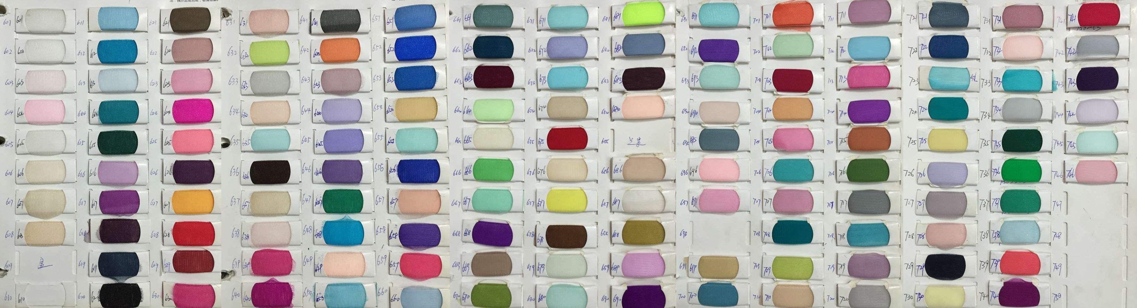 Row of colorful spools of thread in various shades.