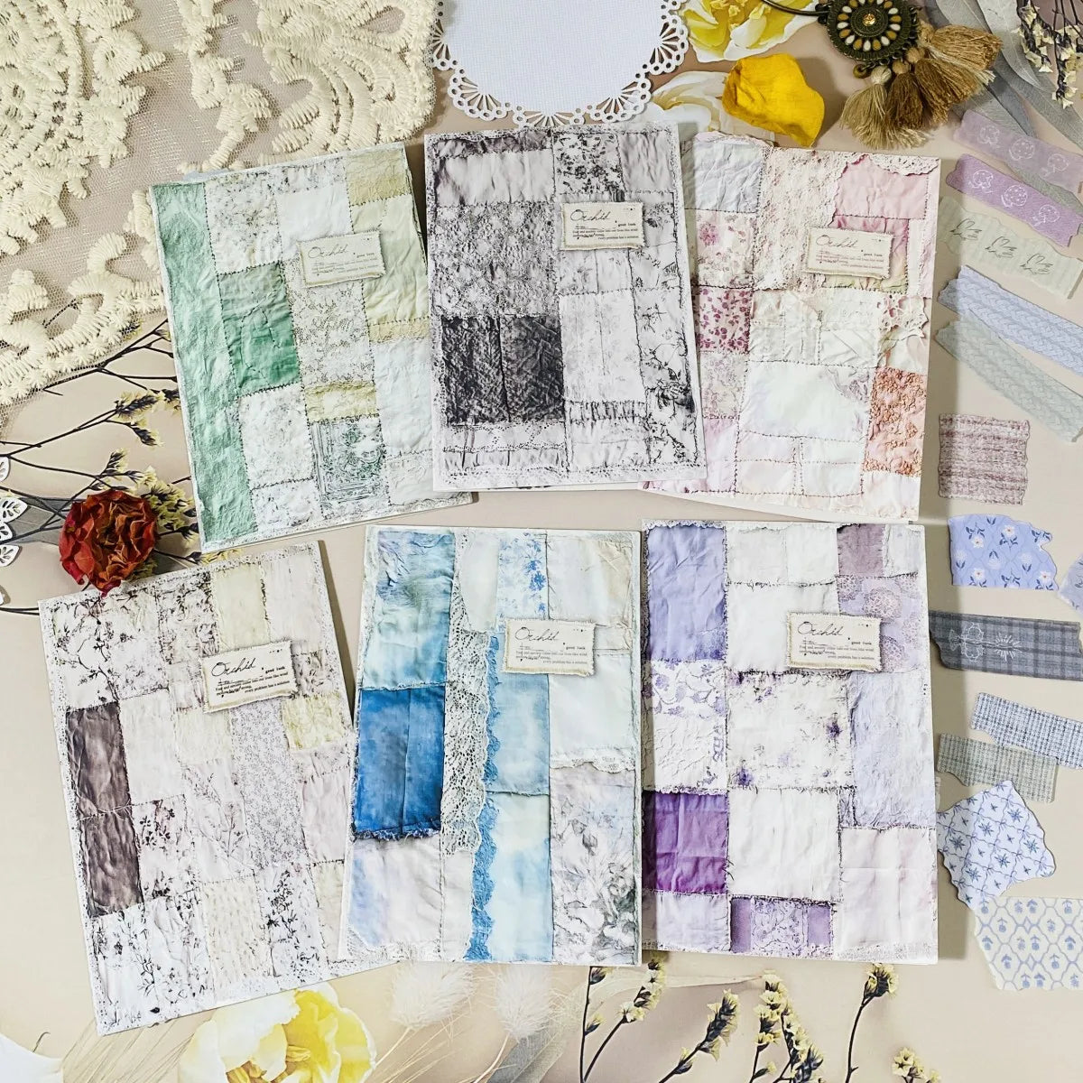 Collection of textured fabric swatches on a decorative surface with flowers and lace.