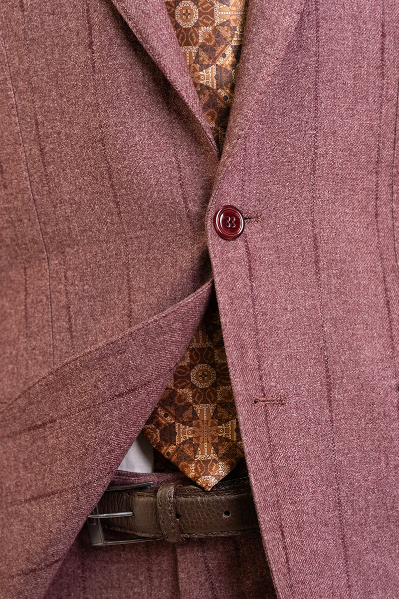 Close-up of a maroon suit jacket with a patterned shirt and belt.