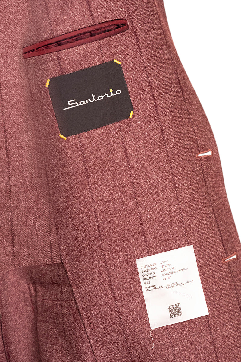 Close-up of a maroon suit with a Sartorio label on a white background