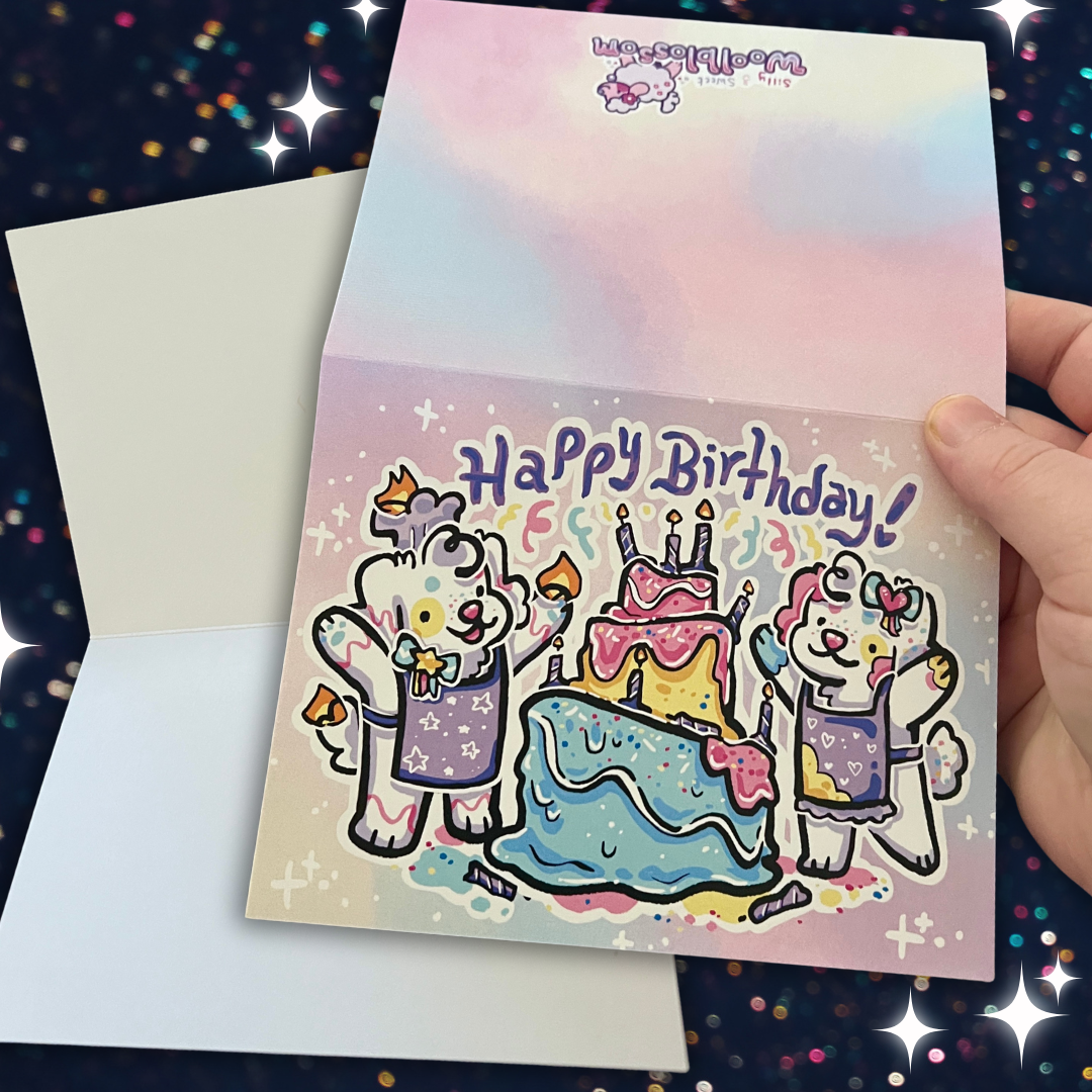 Hand holding a birthday card with cartoon bears and cake illustration