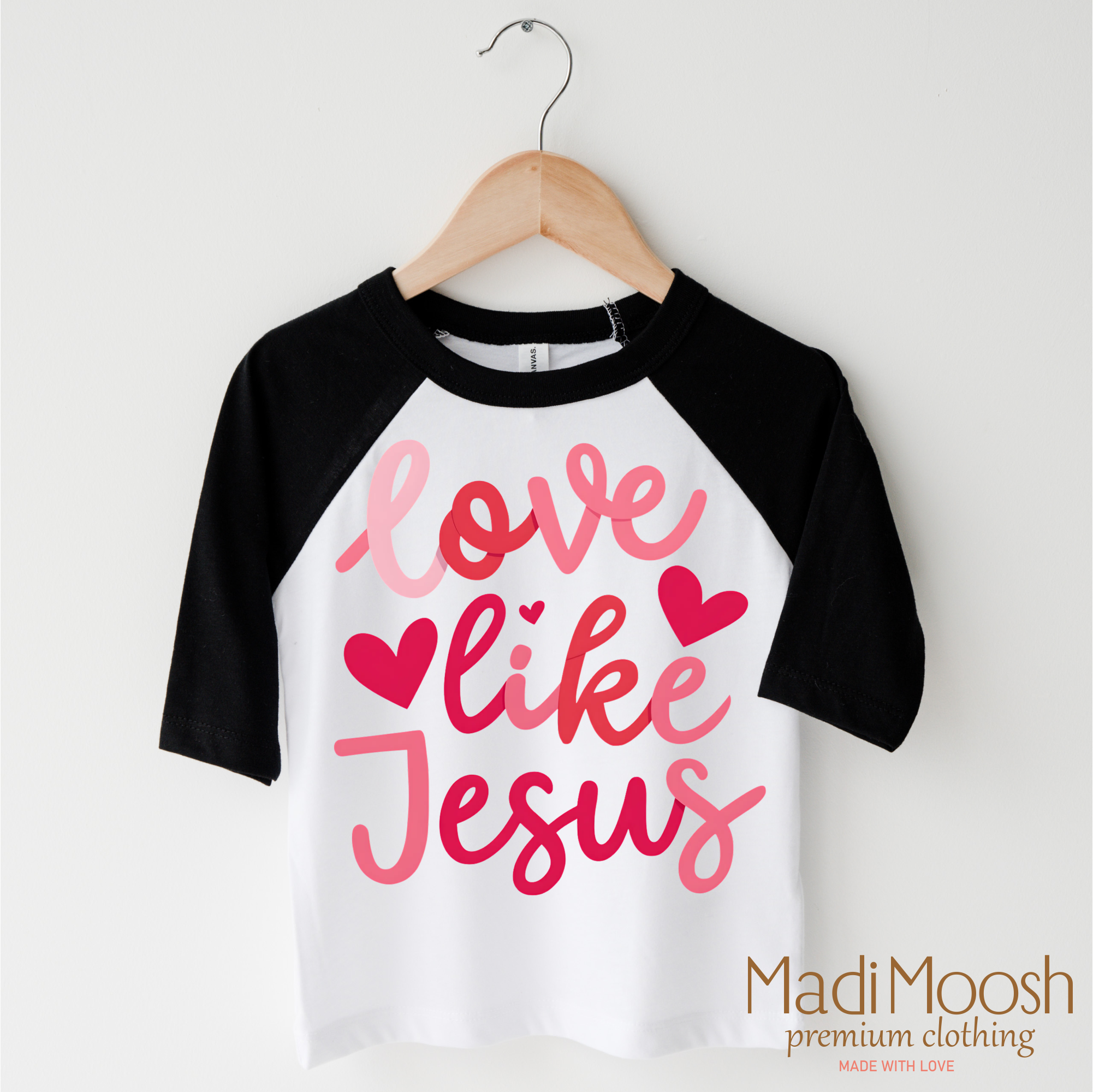 Children's 3/4 sleeve shirt with 'Love like Jesus' text on a hanger, branded as Madi Moosh.