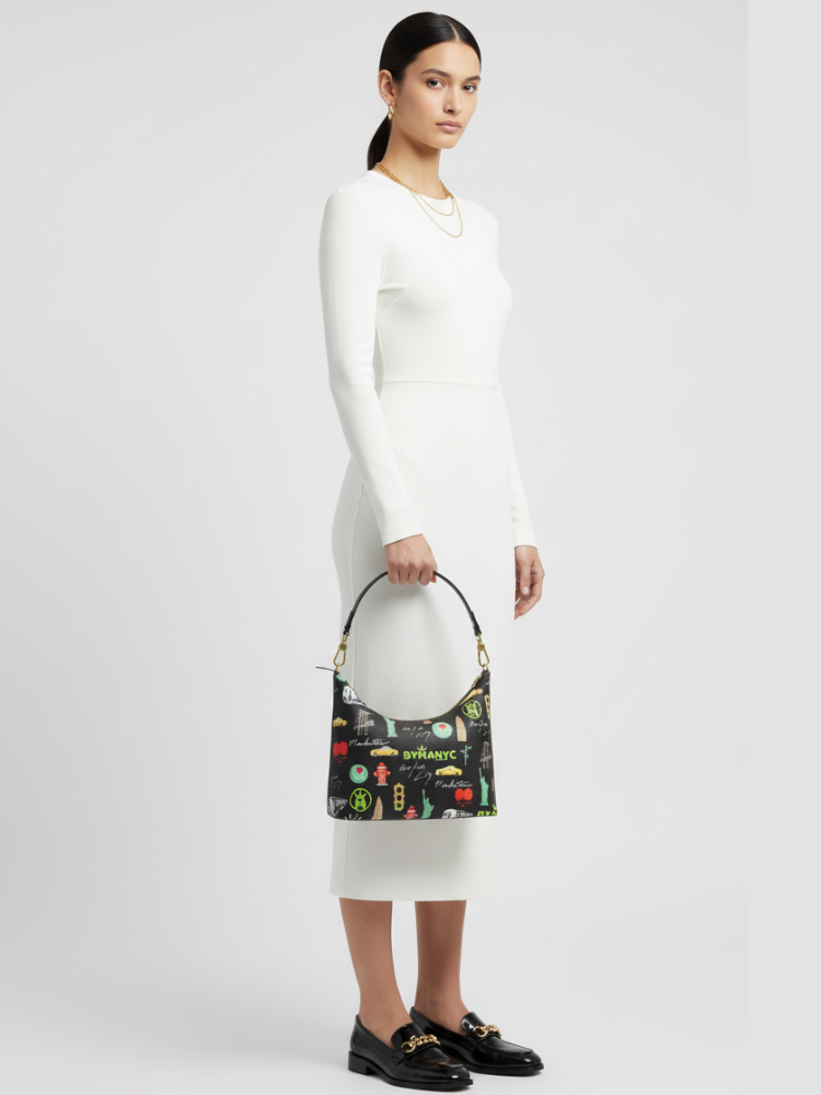 Woman holding a patterned handbag against a plain background