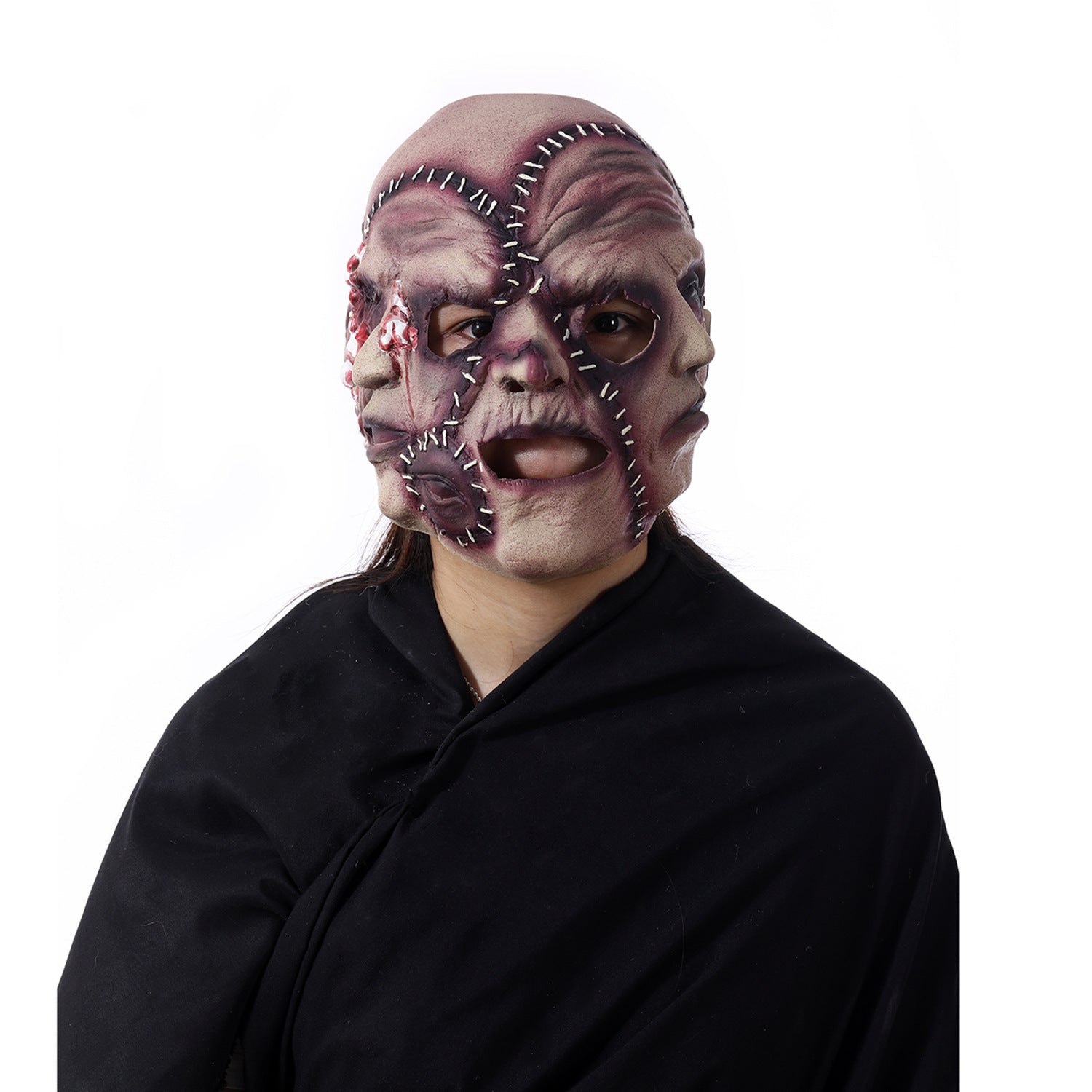 Person wearing a detailed mask with stitches and black clothing on a white background