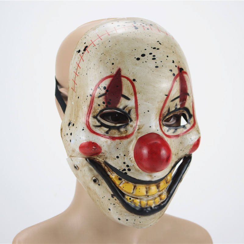 Clown mask with red nose and black accents on a mannequin head against a white background