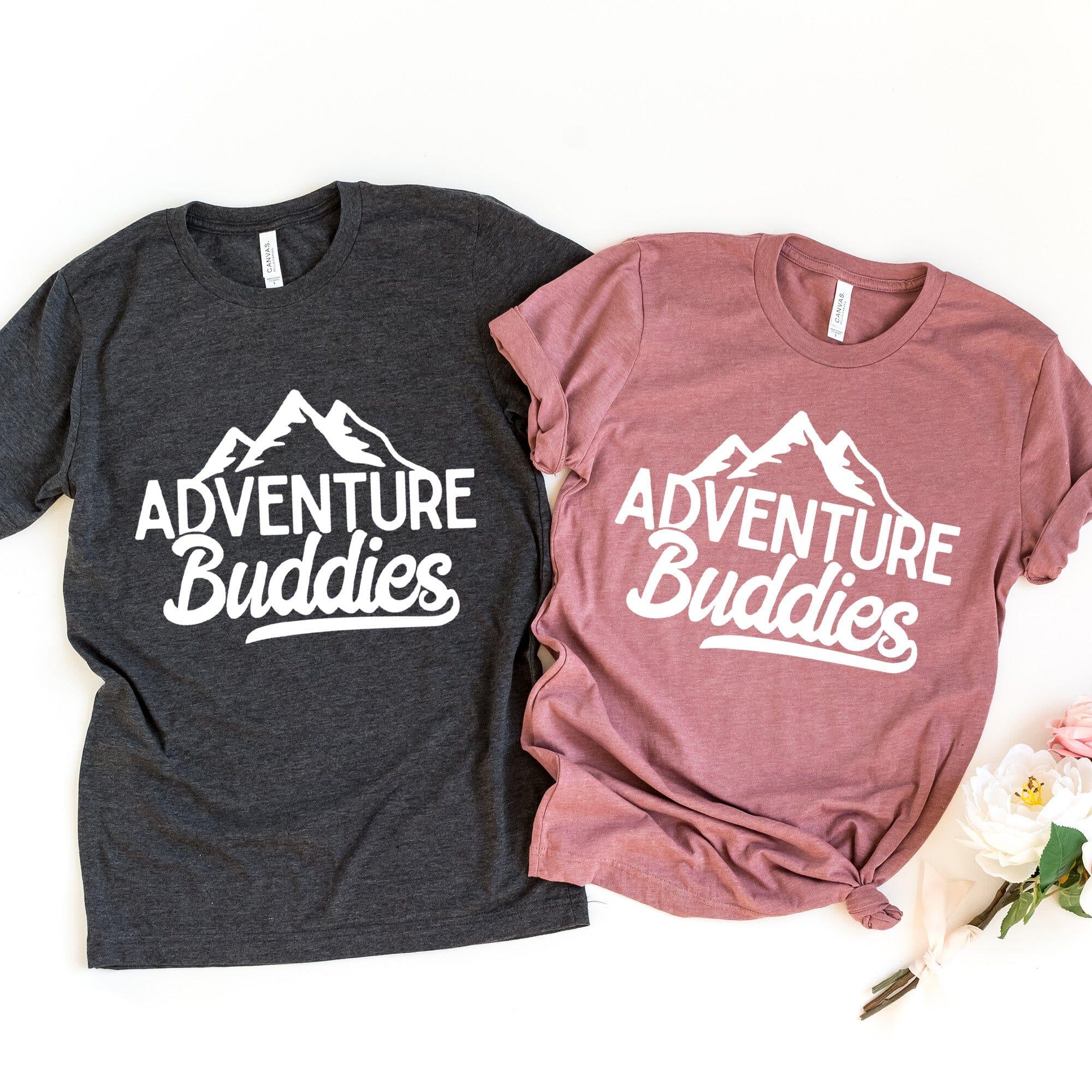Two t-shirts with 'Adventure Buddies' text and mountain graphic on a white background.