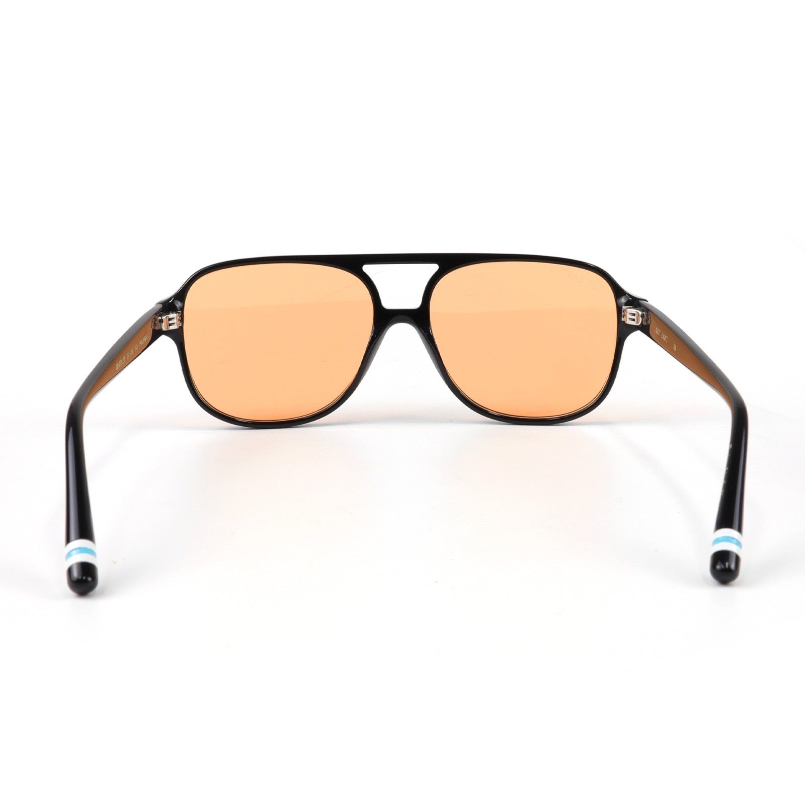 Sunglasses with black frame and orange lenses on a white background