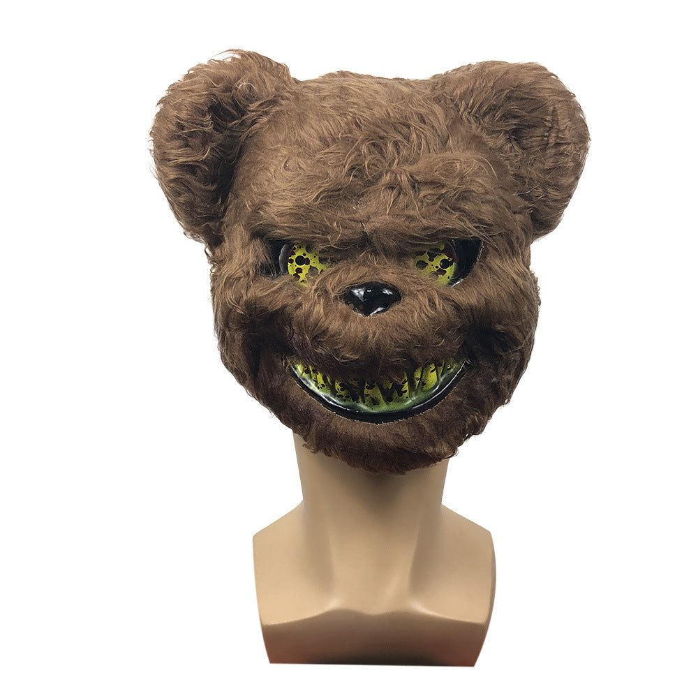 Brown furry mask with green eyes and teeth on a mannequin head against a white background