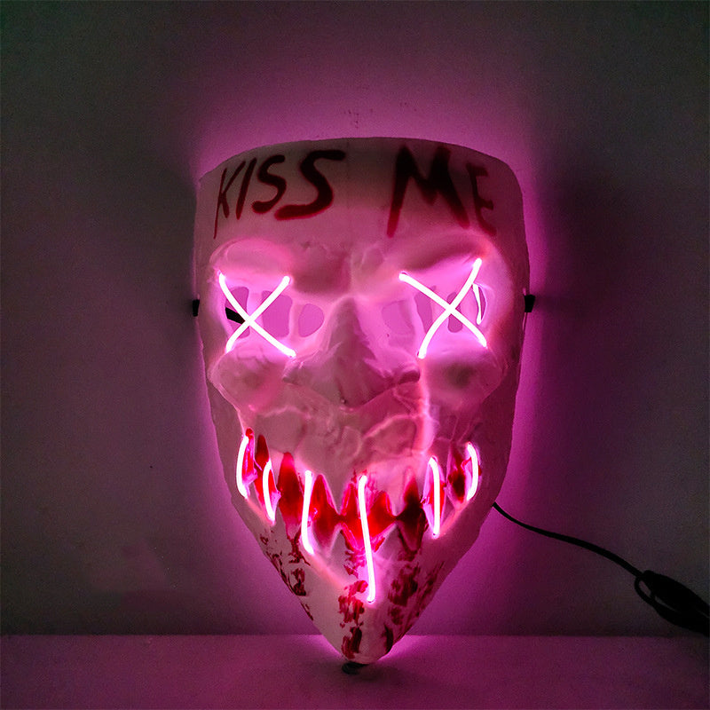 LED mask with 'KISS ME' text and glowing pink and red lights on a dark background