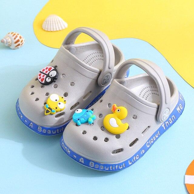 Children's clogs with colorful character charms on a blue and yellow background