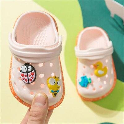 Pink children's sandals with cartoon characters on a colorful background