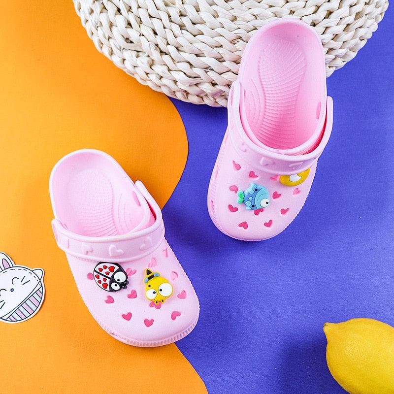Pink children's clogs with cartoon characters on a colorful background