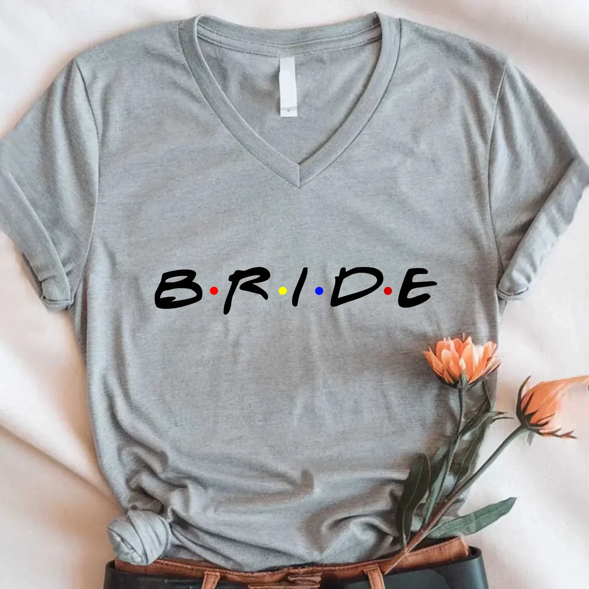 Gray t-shirt with 'BRIDE' text in rainbow colors on a white background