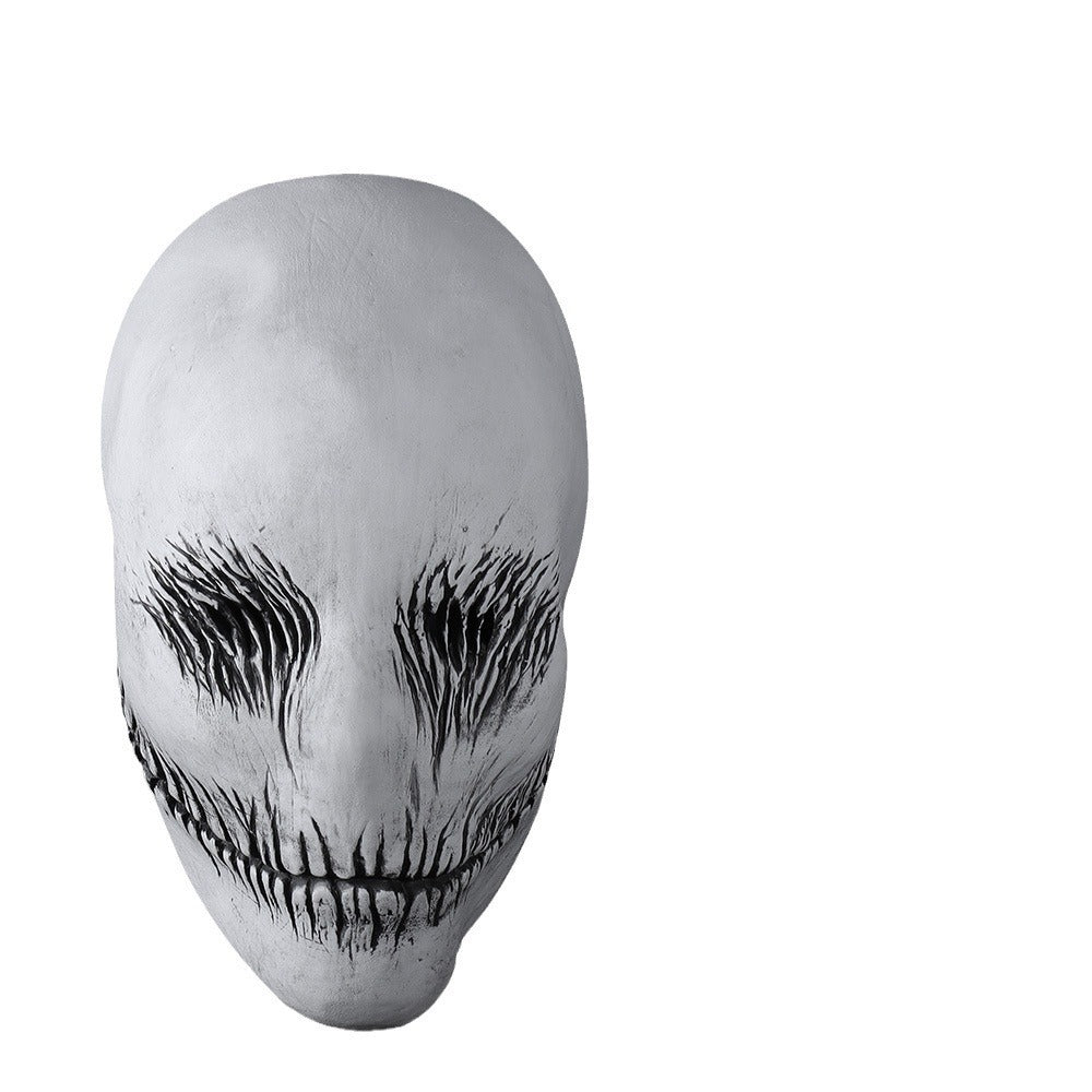 White mask with black eye and mouth designs on a white background